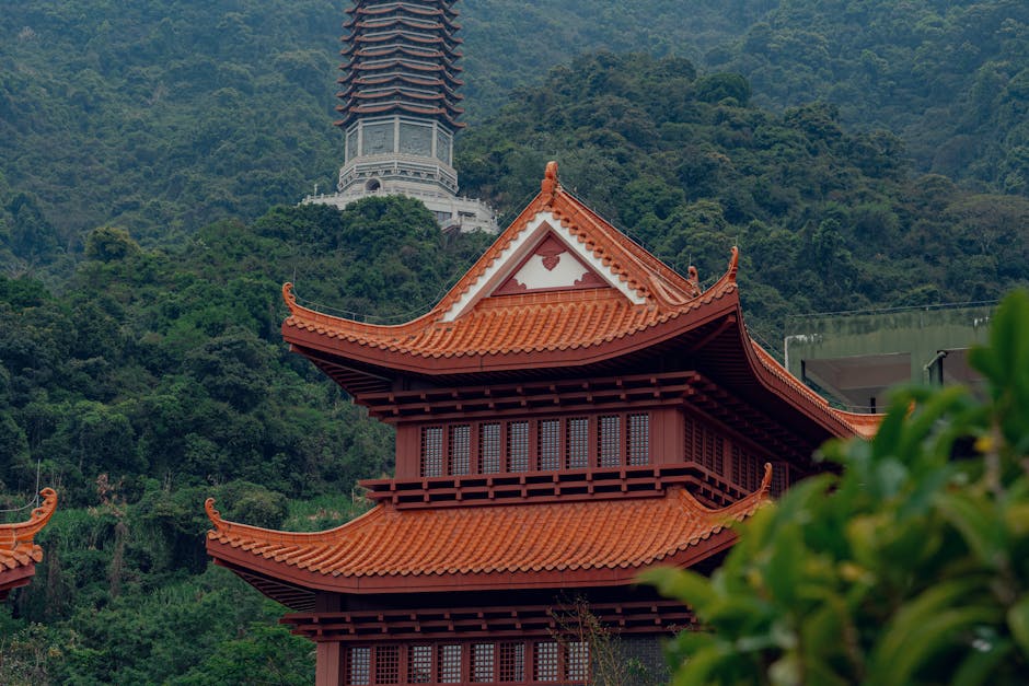 Serene view of a traditional pagoda surrounded by lush mountain greenery, perfect for travel and architecture themes.